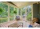 Cozy screened-in patio with comfortable seating and views of the lush, wooded backyard at 4275 Green Summers Dr, Cumming, GA 30028