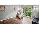 Cozy sitting room with hardwood floors, a comfortable chaise lounge, and a large window overlooking greenery at 4275 Green Summers Dr, Cumming, GA 30028
