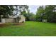 Large backyard with grassy lawn, mature trees and landscaping at 6109 N Main Se St, Acworth, GA 30101