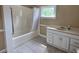 Bright bathroom with large tub, tiled floors and white vanity at 6109 N Main Se St, Acworth, GA 30101