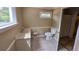 Clean bathroom with tiled floors, vanity, toilet and window at 6109 N Main Se St, Acworth, GA 30101