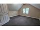 Neutral bedroom featuring a window, plush gray carpeting, an interior door, and an open space at 6109 N Main Se St, Acworth, GA 30101