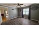 Bedroom with laminate flooring, standard ceiling fan, and neutral paint at 6109 N Main Se St, Acworth, GA 30101