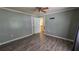 Bedroom with laminate flooring, standard ceiling fan, and neutral paint at 6109 N Main Se St, Acworth, GA 30101