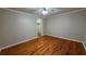 Bedroom features hardwood floors, standard ceiling fan, and closet at 6109 N Main Se St, Acworth, GA 30101