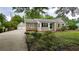 Charming home with stone accents, a well-maintained yard, and a detached two-car garage at 6109 N Main Se St, Acworth, GA 30101