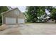 Detached garage with concrete drive, landscaping and trees at 6109 N Main Se St, Acworth, GA 30101