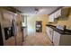 Traditional kitchen with stainless steel appliances, tile floors and modern lighting at 6109 N Main Se St, Acworth, GA 30101