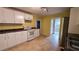 Traditional kitchen with white cabinets, tile floors and large window at 6109 N Main Se St, Acworth, GA 30101