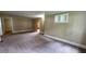 Large living room with carpet flooring and neutral color scheme at 6109 N Main Se St, Acworth, GA 30101