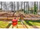 Backyard featuring an outdoor kitchen area and wooden steps leading to a spacious upper yard at 845 Connell Ln, Lawrenceville, GA 30044