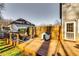 Backyard wooden deck with a pet house, privacy fence, and comfortable seating area at 845 Connell Ln, Lawrenceville, GA 30044