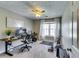 Well-lit bedroom features a ceiling fan, gray walls, plush carpet, and large window for a modern home office setup at 845 Connell Ln, Lawrenceville, GA 30044