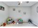 Bright bedroom features a ceiling fan, gray walls, plush carpet, and play items for a fun and cozy ' space at 845 Connell Ln, Lawrenceville, GA 30044