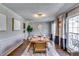 Formal dining room with paneled walls, hardwood floors, seating for six and bright natural light at 845 Connell Ln, Lawrenceville, GA 30044