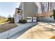 Two-story home with gray siding, white garage doors, and backyard access from a elevated wooden stairs at 845 Connell Ln, Lawrenceville, GA 30044