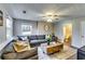 Comfortable living room with a plush gray sectional sofa, stylish wooden coffee table, and a well-lit bathroom at 845 Connell Ln, Lawrenceville, GA 30044