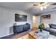 Inviting living room featuring gray sectional sofa, sleek console, and modern decor, creating a cozy gathering space at 845 Connell Ln, Lawrenceville, GA 30044