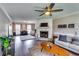 Inviting living room with a fireplace, modern ceiling fan, hardwood floors and lots of natural light at 845 Connell Ln, Lawrenceville, GA 30044