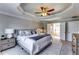 This luxurious main bedroom features a tray ceiling and an ensuite bathroom with a garden tub at 845 Connell Ln, Lawrenceville, GA 30044