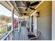 Inviting covered front porch with ceiling fans, stylish decor, and ample space for relaxation and enjoying the outdoors at 845 Connell Ln, Lawrenceville, GA 30044