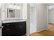 Ensuite bathroom shows granite vanity, black drawers, large mirror, and a view of the shower through an open doorway at 111 Abingdon Way, Sandy Springs, GA 30328