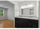 Bathroom featuring double vanity, modern lighting, and granite counters at 111 Abingdon Way, Sandy Springs, GA 30328