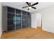 Bedroom view features a large closet with mirrored doors and a ceiling fan at 111 Abingdon Way, Sandy Springs, GA 30328