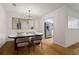 Dining area features hardwood floors, modern chandelier, and view to kitchen at 111 Abingdon Way, Sandy Springs, GA 30328