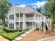 Charming home with double balconies, grey siding, a landscaped yard, and inviting entrance at 111 Abingdon Way, Sandy Springs, GA 30328