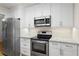Well-equipped kitchen with stainless steel appliances and white cabinets at 111 Abingdon Way, Sandy Springs, GA 30328