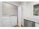 Functional laundry area with washer, dryer, and additional cabinet space at 111 Abingdon Way, Sandy Springs, GA 30328