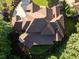 Aerial view of a large home with an expansive roof surrounded by mature trees at 5114 Brendlynn Dr, Suwanee, GA 30024