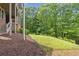 A view of the landscaped backyard, mulch, and lawn at 5114 Brendlynn Dr, Suwanee, GA 30024