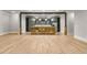 Spacious finished basement featuring a stone bar with a sink, recessed lighting, and light hardwood flooring at 5114 Brendlynn Dr, Suwanee, GA 30024