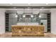 Basement wet bar with stainless refrigerator, stone accents, undermount sink, granite countertops, and shaker cabinetry at 5114 Brendlynn Dr, Suwanee, GA 30024