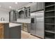 Basement wet bar featuring a wine cooler, stainless refrigerator, granite countertops, cabinets, and lighting at 5114 Brendlynn Dr, Suwanee, GA 30024