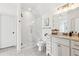Well-lit bathroom features a glass-enclosed shower, marble countertop vanity, and modern fixtures at 5114 Brendlynn Dr, Suwanee, GA 30024