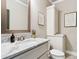 This updated bathroom features a marble countertop and a stylish framed mirror at 5114 Brendlynn Dr, Suwanee, GA 30024