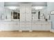 Elegant bathroom featuring a double vanity with marble countertops, custom cabinetry, and modern lighting fixtures at 5114 Brendlynn Dr, Suwanee, GA 30024