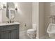 Powder room featuring a granite countertop, vanity, toilet, and urinal at 5114 Brendlynn Dr, Suwanee, GA 30024