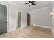 Well-lit bedroom with modern wall sconces and hardwood floors at 5114 Brendlynn Dr, Suwanee, GA 30024