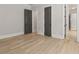 A spacious bedroom features hardwood floors, neutral walls, and bright white trim at 5114 Brendlynn Dr, Suwanee, GA 30024