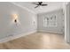 Bright bedroom with sconces and a ceiling fan at 5114 Brendlynn Dr, Suwanee, GA 30024