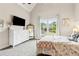 Comfortable bedroom with natural light, dresser, and mirror creates a serene and inviting space at 5114 Brendlynn Dr, Suwanee, GA 30024
