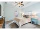 Cozy bedroom with tray ceiling, ceiling fan, and carpet flooring, creating a serene and inviting space at 5114 Brendlynn Dr, Suwanee, GA 30024