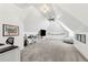 Spacious bonus room with vaulted ceilings, fan, carpet and ample space for various activities at 5114 Brendlynn Dr, Suwanee, GA 30024