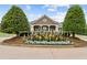 Well-maintained clubhouse featuring manicured landscaping and colorful flower beds at 5114 Brendlynn Dr, Suwanee, GA 30024