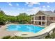Large community swimming pool and water slide with ample seating and manicured landscaping at 5114 Brendlynn Dr, Suwanee, GA 30024