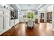 Dining area with wainscoting, custom cabinetry, and chandelier showcases the open floor plan at 5114 Brendlynn Dr, Suwanee, GA 30024